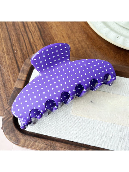 Model wearing Beau Candy Polka Dot acetate claw clip in styled hair