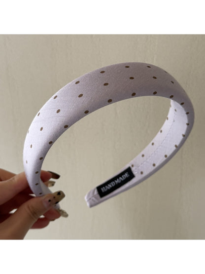 Top view of colorful polka dot headband with twisted knot design
