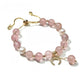 Lovra pink crystal beaded bracelet styled with complementary jewelry on a model's wrist