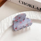 Beau shark claw clip with blue floral print against neutral background
