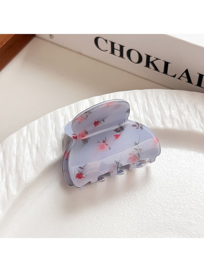 Beau shark claw clip with blue floral print against neutral background
