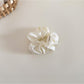 Beige satin bow scrunchie laid flat showing the elastic band inside