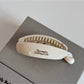 Beau minimalist stick hair clip displayed alongside matching hair accessories