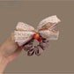 Close-up of Gifty Strawberry Charm Lace Bow Scrunchie with red strawberry charm and white lace bow