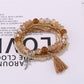 Lovra boho tassel bracelet with wooden and glass beads close-up
