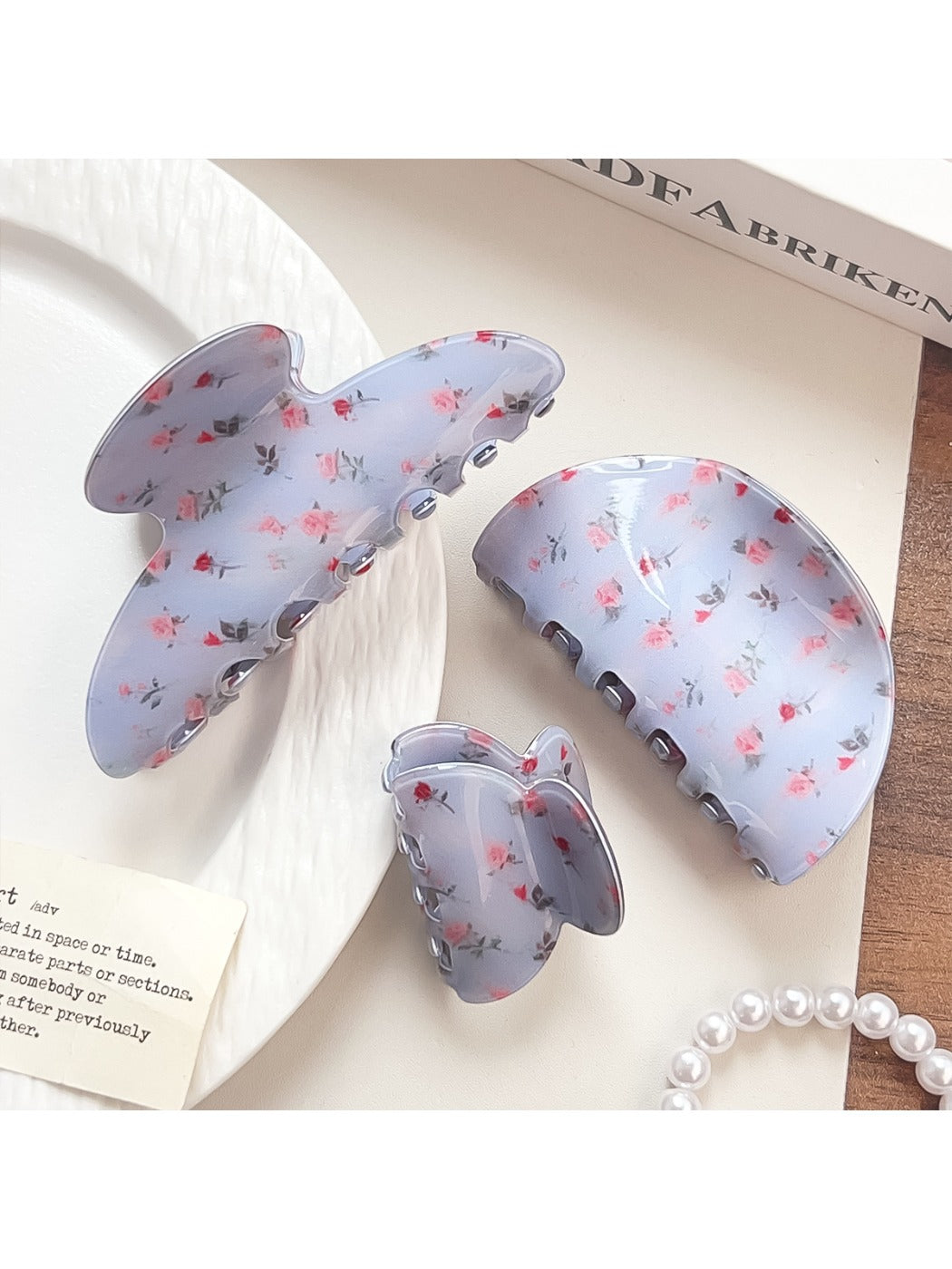 Close-up of blue floral pattern on Beau shark claw clip