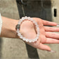 Lovra clear quartz bracelet displayed on a wooden surface