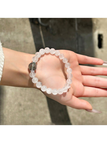 Lovra clear quartz bracelet displayed on a wooden surface