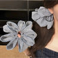 Gifty scrunchie worn on wrist with classic black and white check design