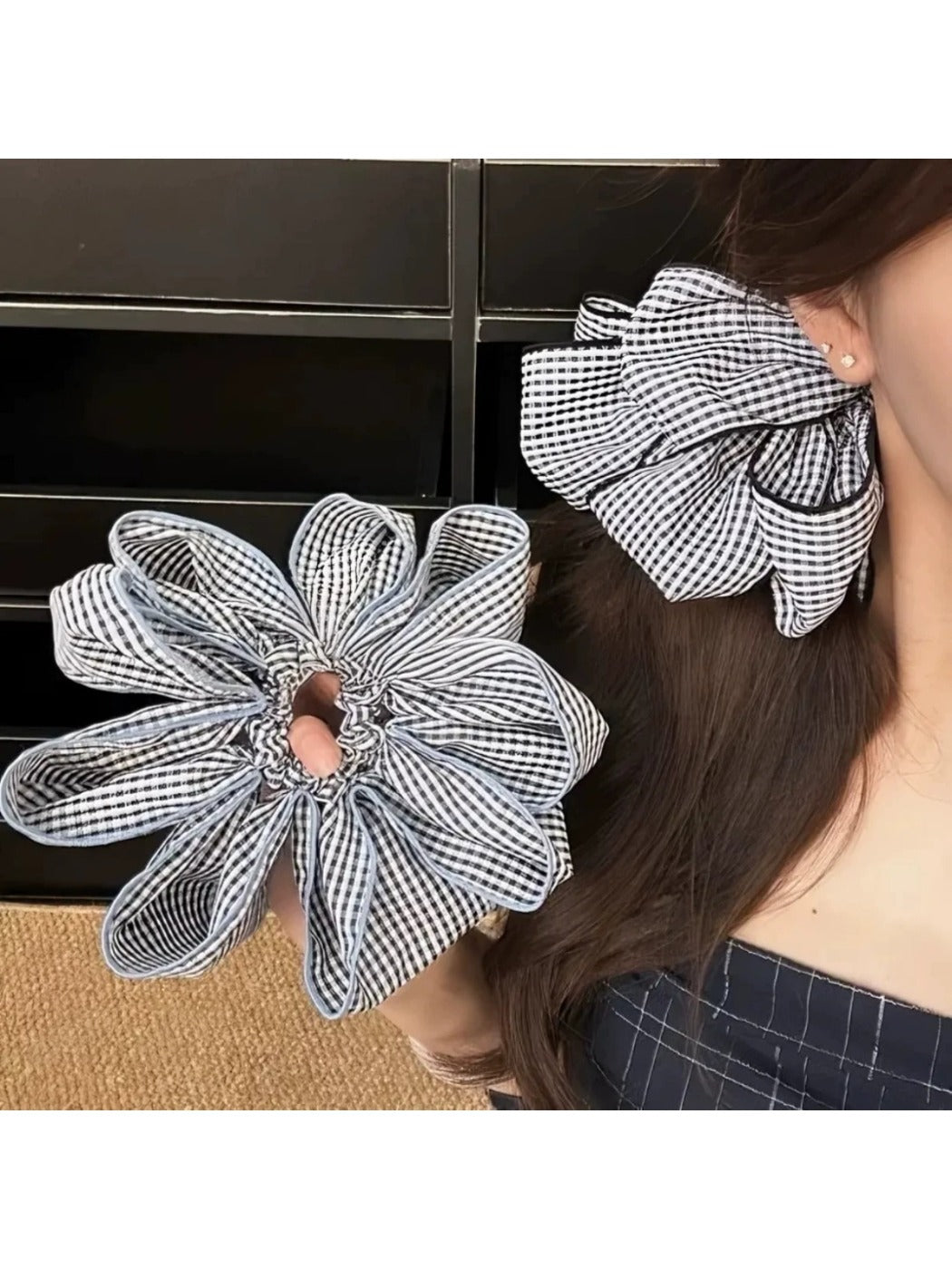 Gifty scrunchie worn on wrist with classic black and white check design