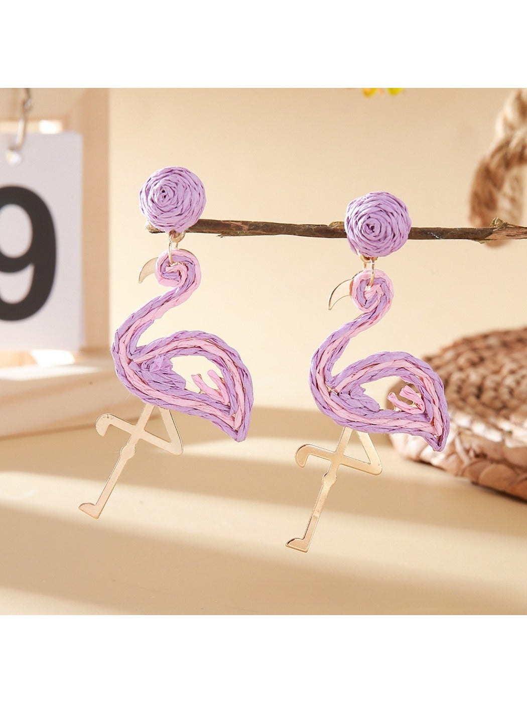 Flamingo pendant earrings packaged in a small jewelry box with a soft lining