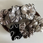 Gifty satin scrunchie with ruffled texture displayed on a white background