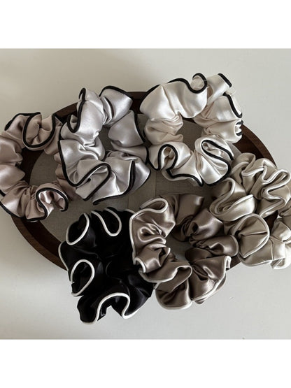 Gifty satin scrunchie with ruffled texture displayed on a white background