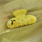 Beau floral crescent hair claw clip displayed on a white background