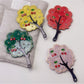 Mirroray tree-shaped handheld mirror held in hand displaying reflective surface