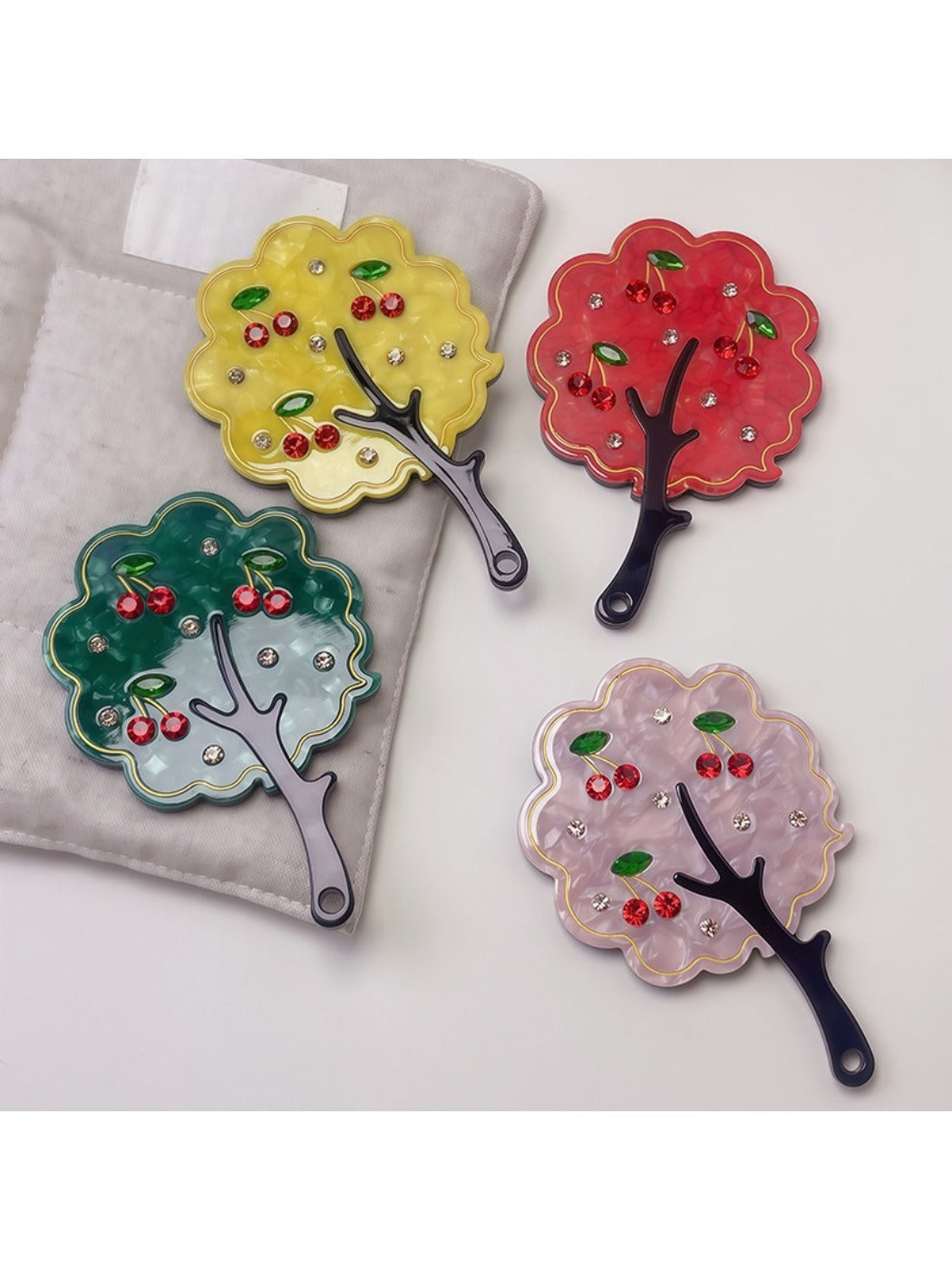 Mirroray tree-shaped handheld mirror held in hand displaying reflective surface