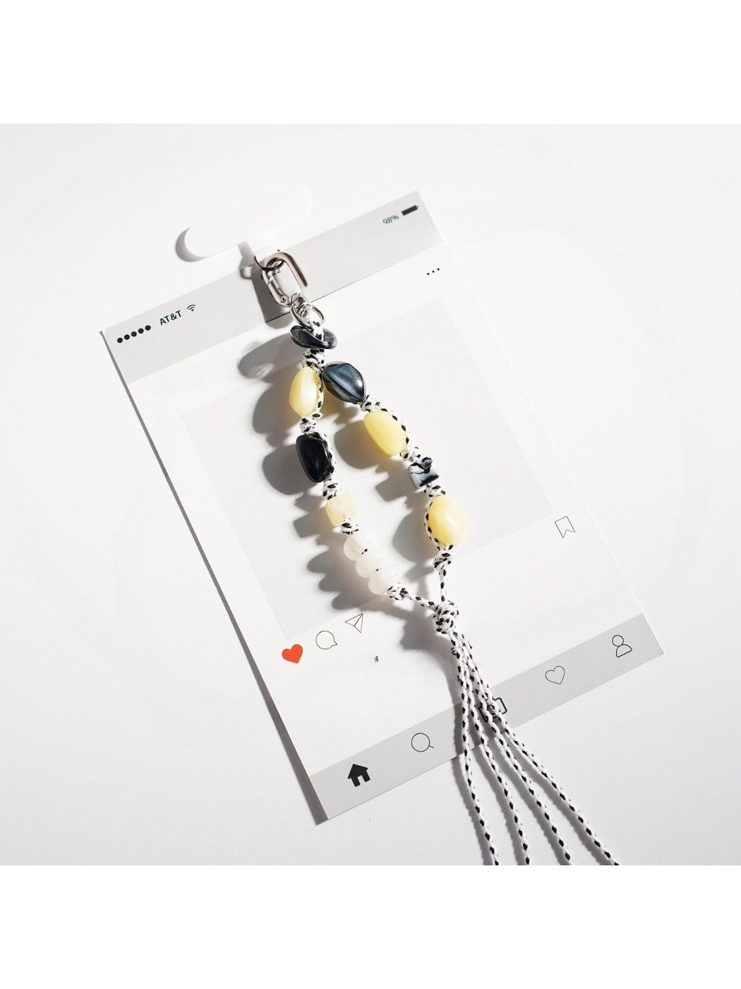 Hand holding a colorful resin bead keychain with a gold ring