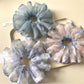 Set of vintage minimalist printed scrunchies in various colors on a white background