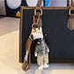 Giraffe charm keychain shown with other animal-themed keychains