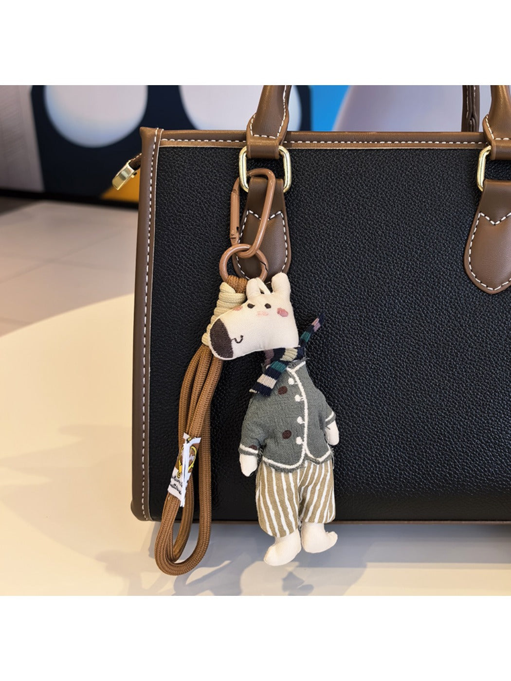Giraffe charm keychain shown with other animal-themed keychains