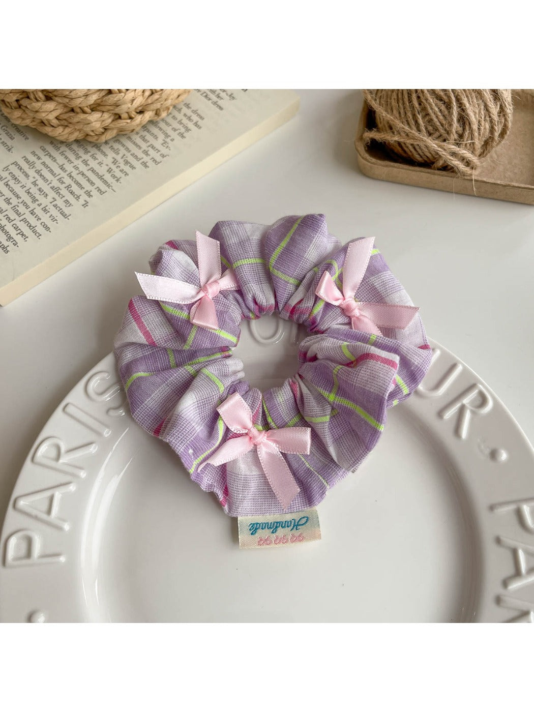 Gifty Ribbon Bow Plaid Scrunchie packaged in a clear plastic bag with branding