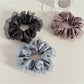 Close-up of Gifty satin tulle scrunchie showing ruffle detail