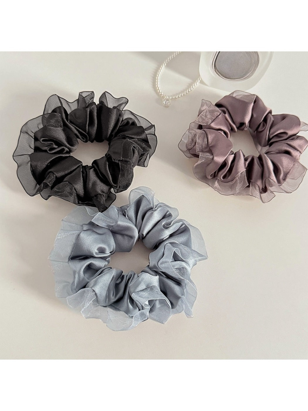 Close-up of Gifty satin tulle scrunchie showing ruffle detail