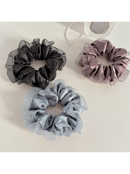 Close-up of Gifty satin tulle scrunchie showing ruffle detail