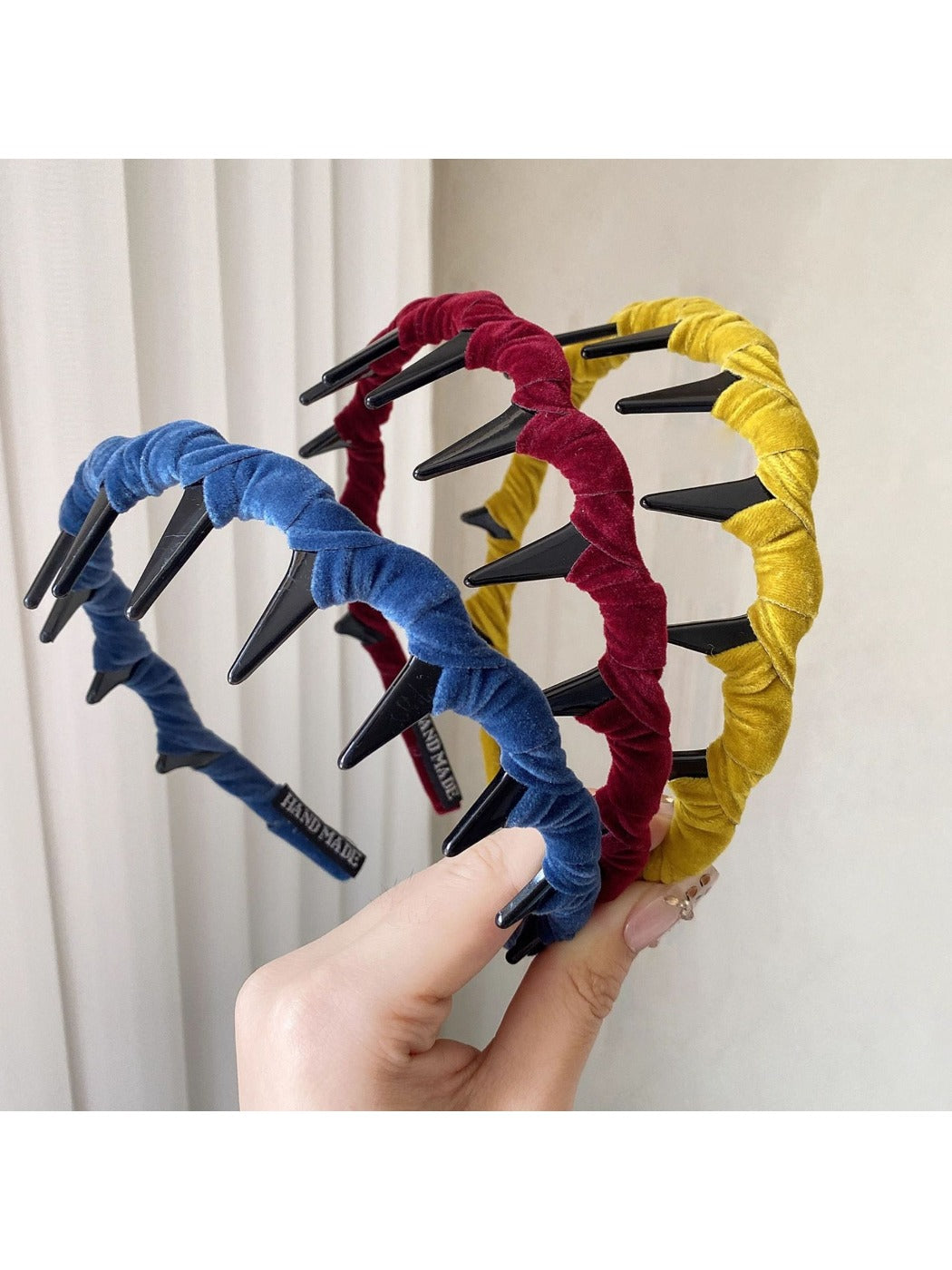 Top view of beige wave toothed headband showing fabric texture