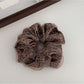 Gifty leopard print tulle scrunchie worn on a wrist as a bracelet