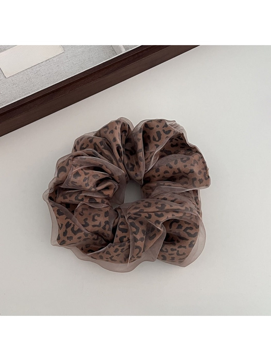 Gifty leopard print tulle scrunchie worn on a wrist as a bracelet