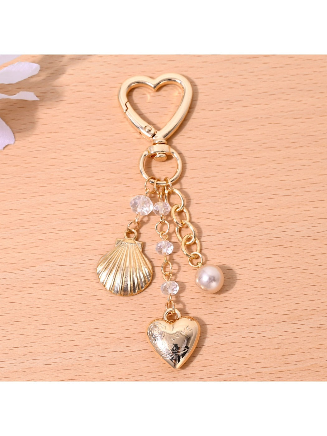 Starfish shaped heart keychain hanging from a bag zipper pull