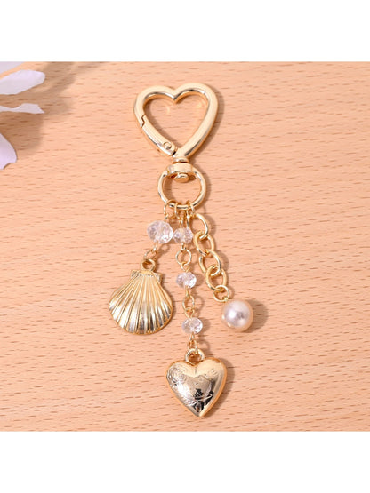 Starfish shaped heart keychain hanging from a bag zipper pull