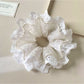 Side view of Gifty minimalist scrunchie highlighting ruffled texture and cutouts