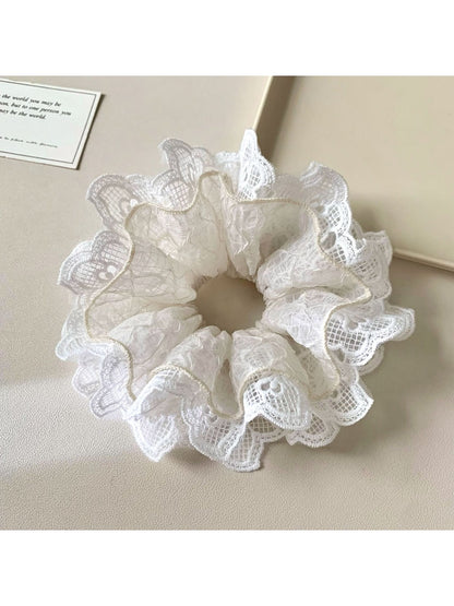 Side view of Gifty minimalist scrunchie highlighting ruffled texture and cutouts