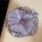 Gifty scrunchie placed next to matching pastel accessories on a flat surface