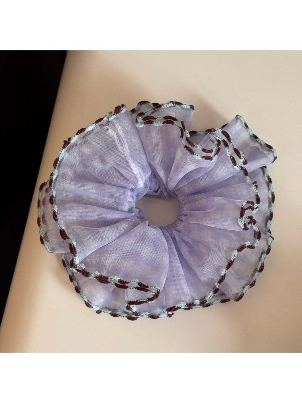 Gifty scrunchie placed next to matching pastel accessories on a flat surface