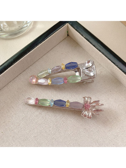 Beau colorful hair clip displayed from side angle, showing clip mechanism and petal details