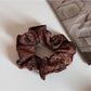 Gifty scrunchie styled in hair, showcasing gentle pastel colors and soft fabric