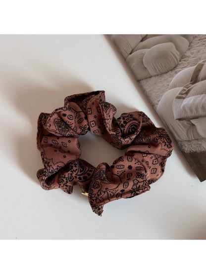 Gifty scrunchie styled in hair, showcasing gentle pastel colors and soft fabric
