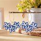 Pair of Earedge Sweet Flower Shaped Drop Earrings hanging from a jewelry stand