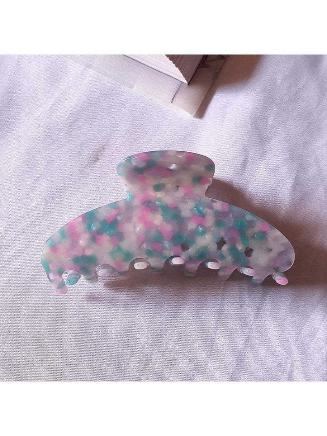 Beau tiny floral acetate claw clip shown with packaging and branding