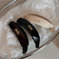 Beau minimalist stick hair clip styled in long brown hair from side view