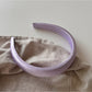 Purple wide edge headband styled with matching accessories