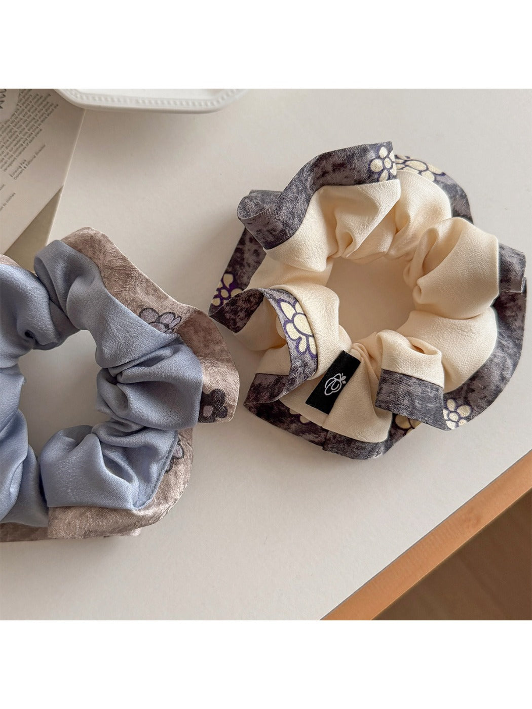 Close-up of Gifty ruffle scrunchie showing fabric texture and color block design