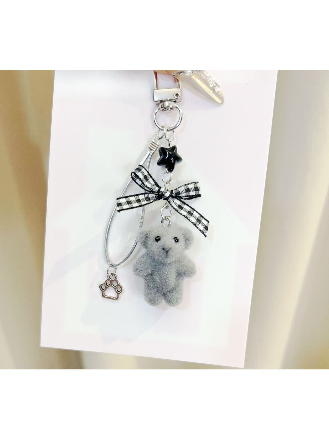 Keypus flocked bear keychain held in hand to show size and texture