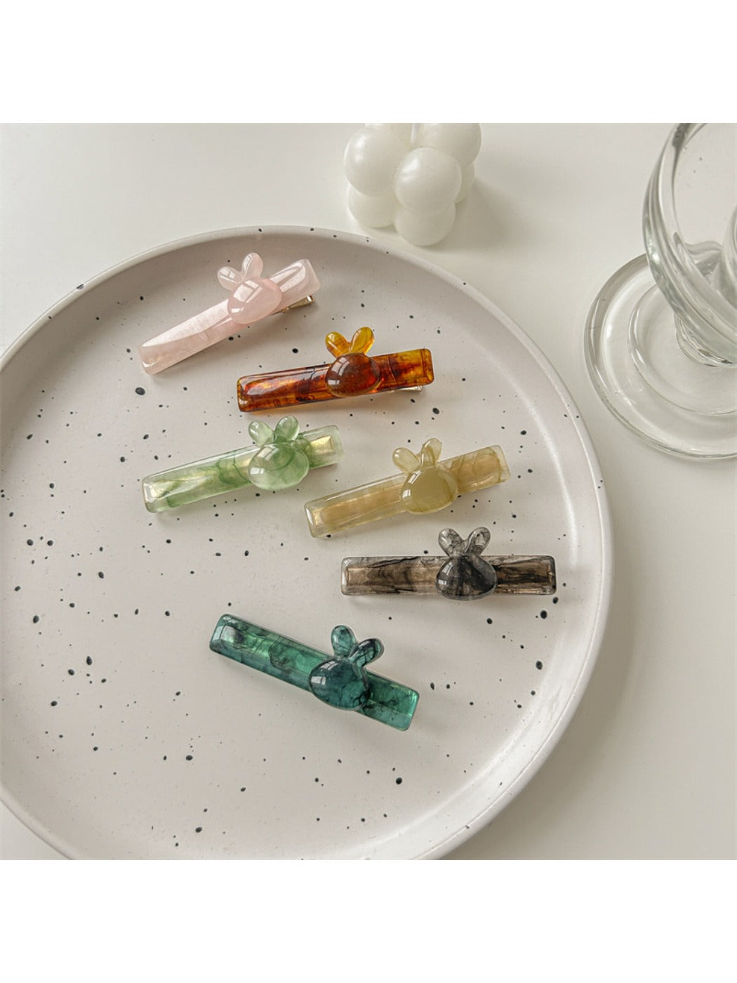 Beau acetate hair clip held in hand showing curved design and clasp