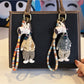 Close-up of a stylish giraffe charm keychain with gold and brown enamel details