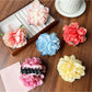 Close-up of Beau lifelike peony flower claw clip in soft pink with detailed petals