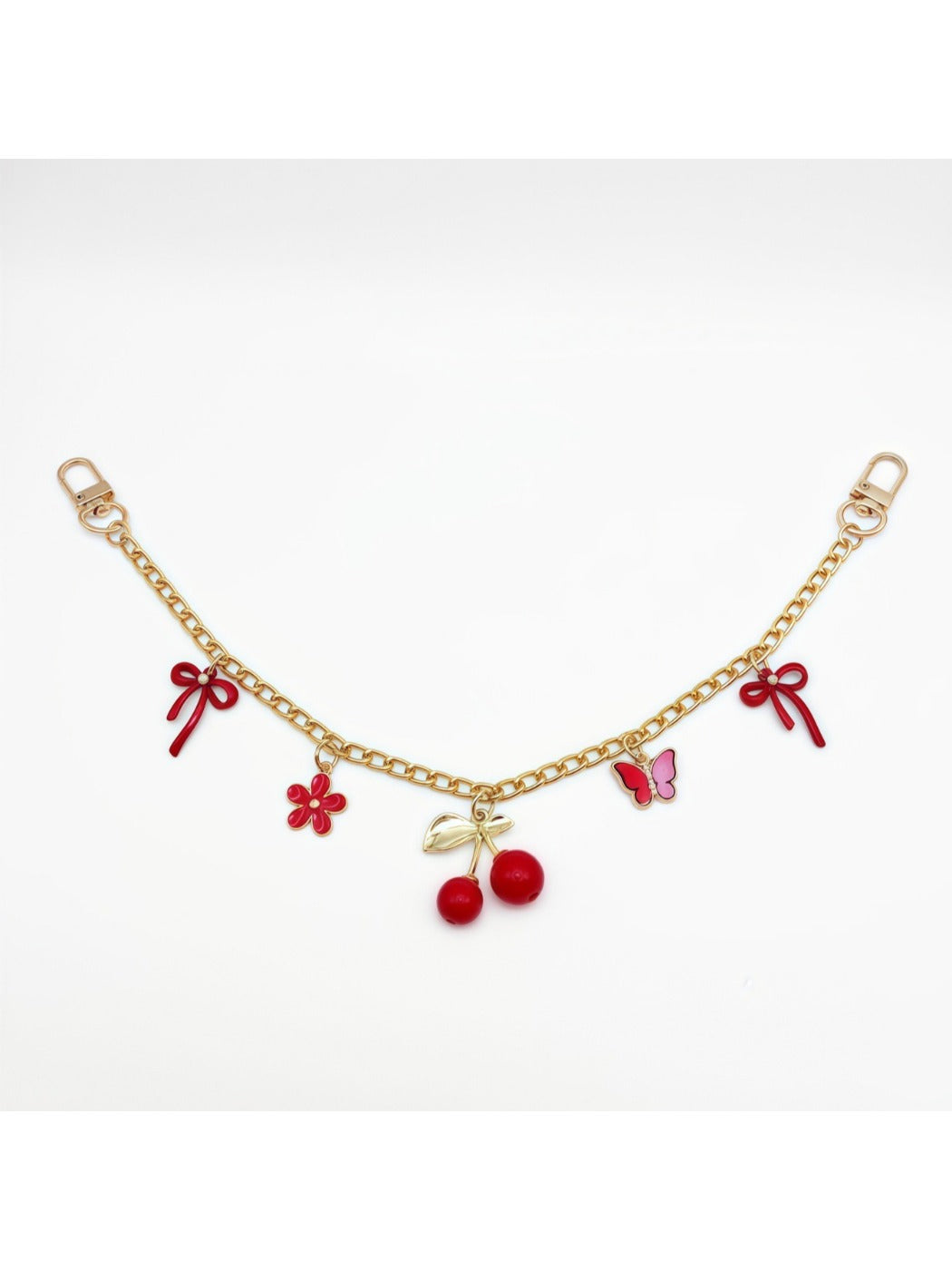 Cherry charm hanging from a set of keys with a blurred background